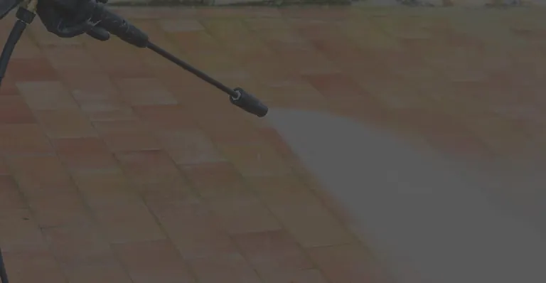 Pressure washing a paved patio in the Outer Banks